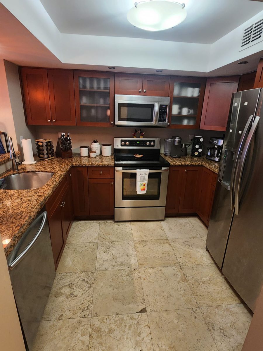Freshly cleaned kitchen with granite countertops and stainless steel appliances